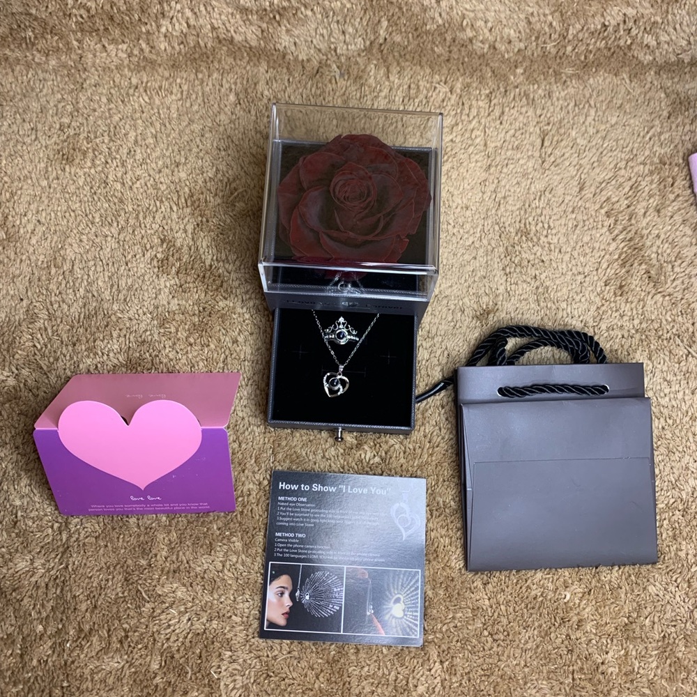 Real rose with necklace and ring